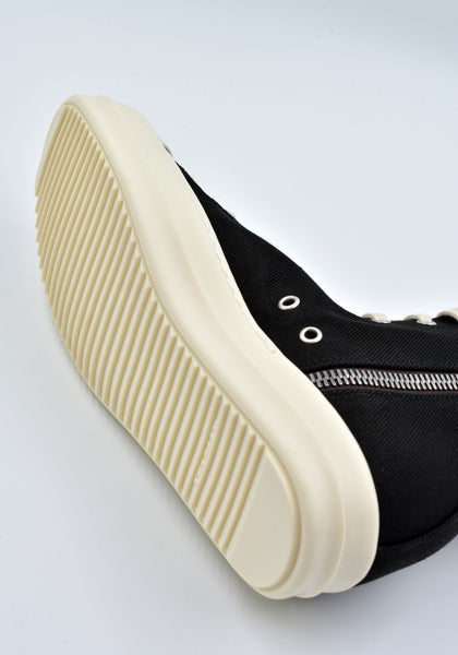 Cargo sneakers featuring a black cotton denim upper, above ankle height, eight eyelets, shoe lace, zipped cargo side pockets, milk white leather toe caps and shark tooth rubber soles